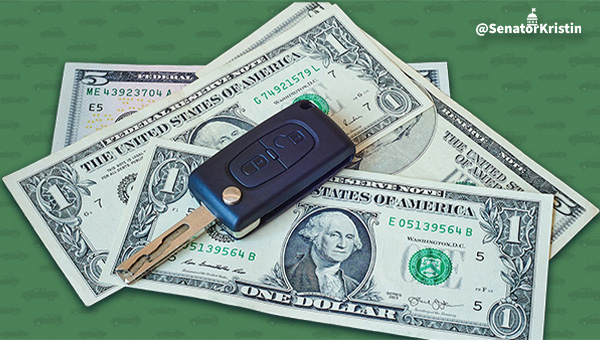 Graphic that reads No More Emissions Testing with a car key sitting on top of money