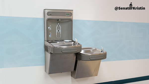 Two drinking water fountains along a wall