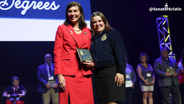 Sen. Phillips-Hill receiving an award from an FFA member.