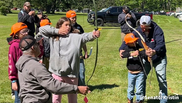 Children receiving an archery lesson