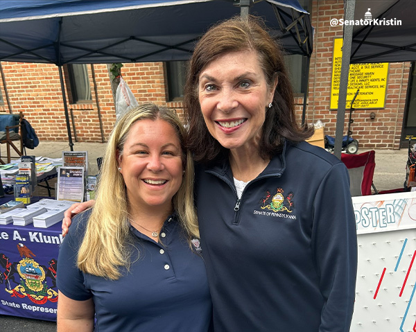 Senator Phillip-Hill and Representative Klunk in front of their stands at the Snack Town Street Fair.