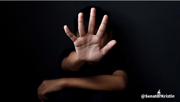 A hand reaching out from a dark background.