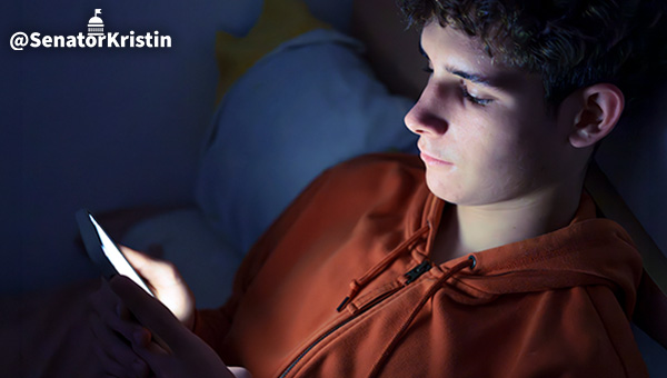 A teen male with a smart phone.