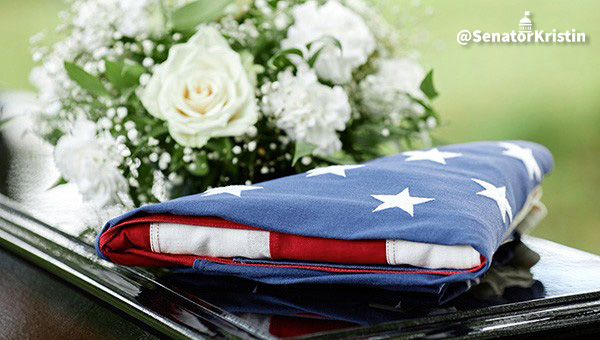 A folded U.S. flag atop a casket.