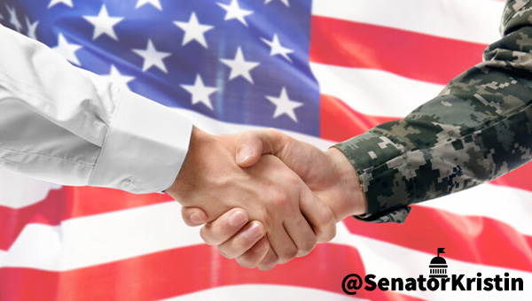Two hands shaking in front of an American flag