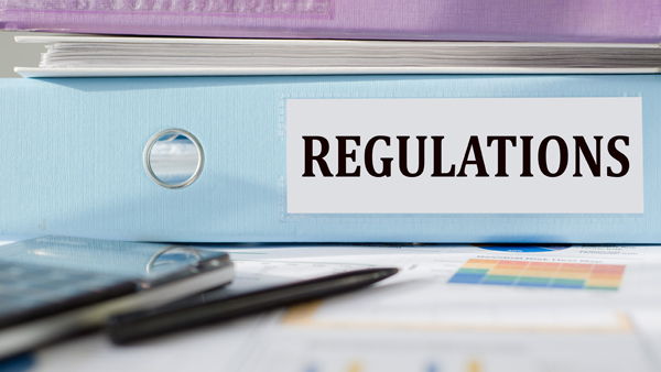 A binder which reads “REGULATIONS” on the spine.
