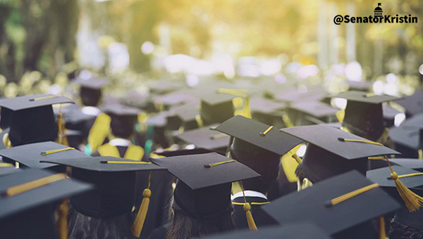 A crowd of people wearing graduation caps and gowns.